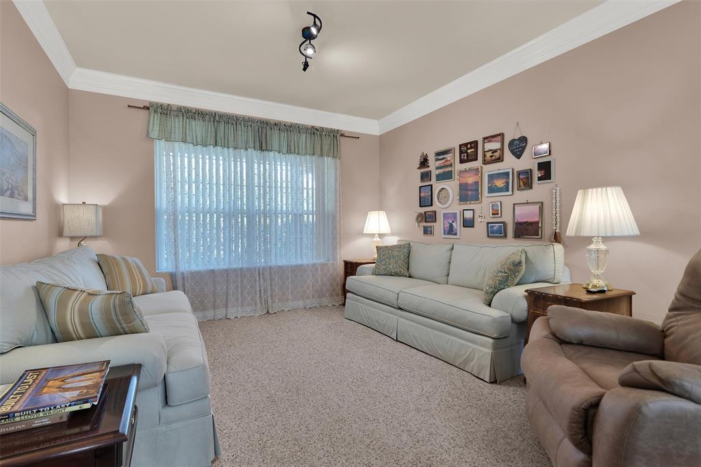 Recessed window with vertical blinds, textured wall finish, crown molding, and track lighting fixture Recessed window with vertical blinds, textured wall finish, crown molding, and track lighting fixture