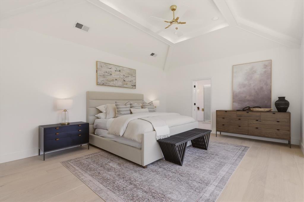 Vaulted ceiling with recessed lighting and a ceiling fan, light wood-finish flooring, and white walls