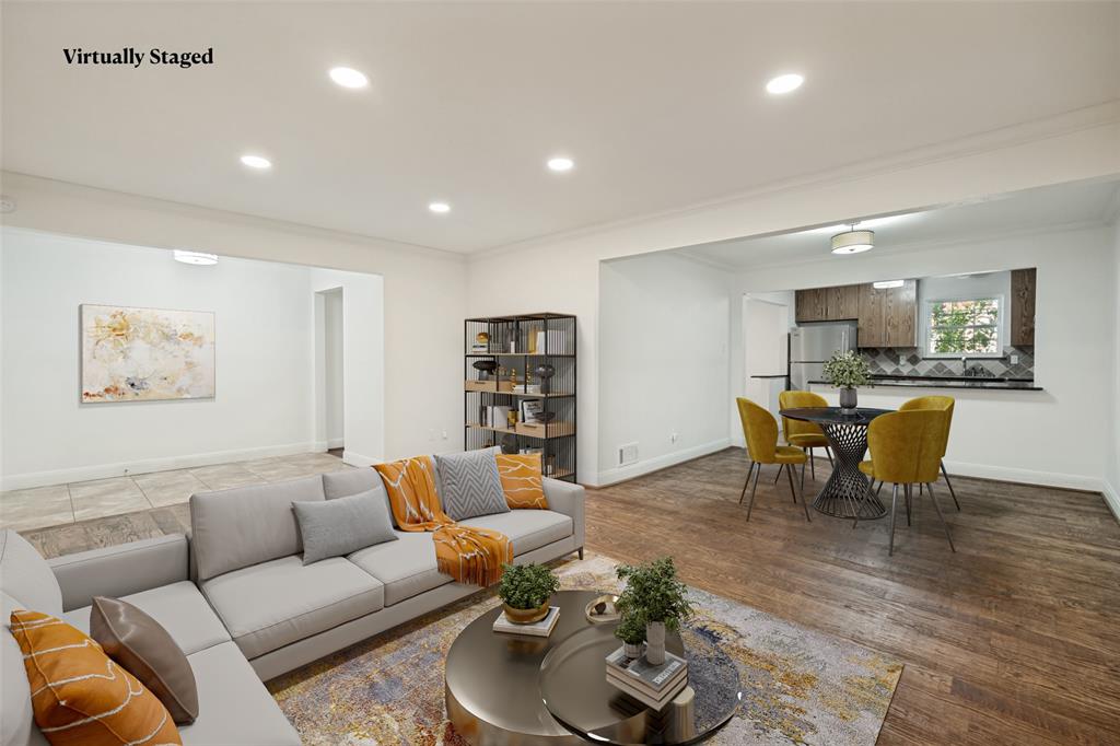 Recessed lighting, wood-finish flooring, white walls, kitchen pass-through, stainless steel refrigerator
