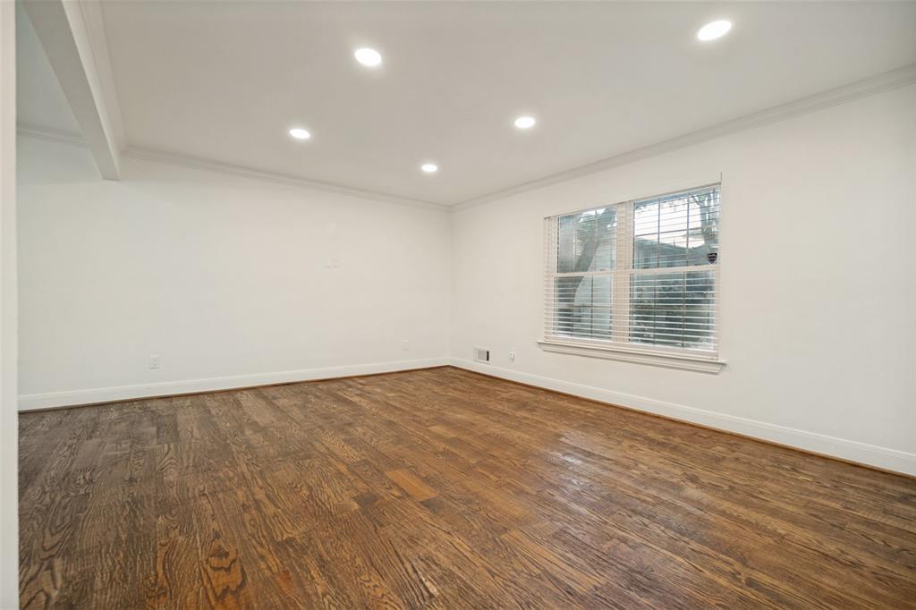 Hardwood flooring, recessed ceiling lighting, crown molding, and a window with blinds
