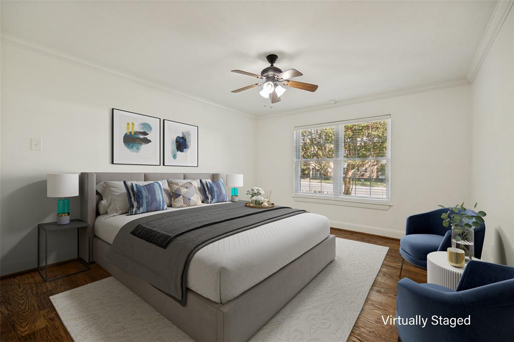 Wood-finish flooring, crown molding, and a ceiling fan with integrated lighting Wood-finish flooring, crown molding, and a ceiling fan with integrated lighting