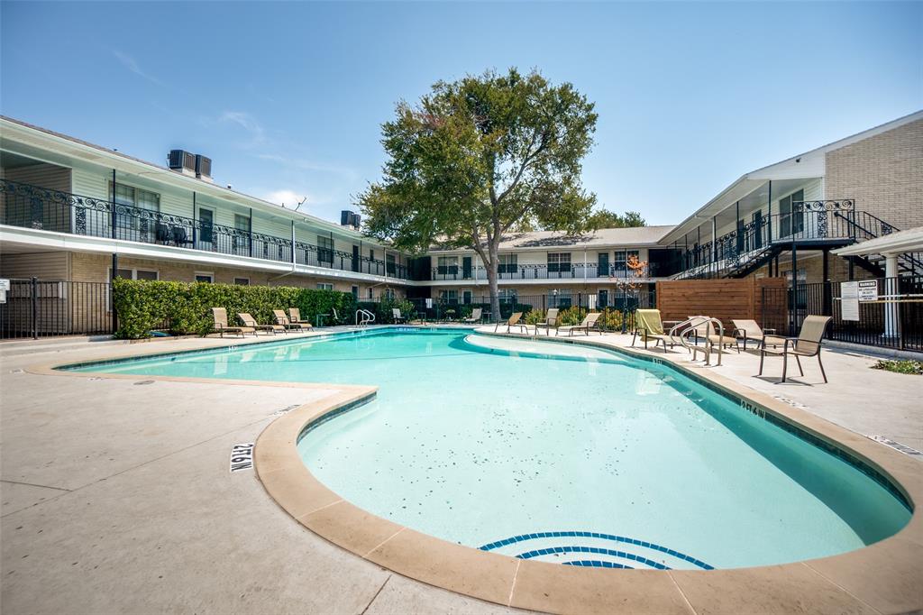 Irregularly shaped swimming pool with a tile-lined entry, surrounded by a concrete deck