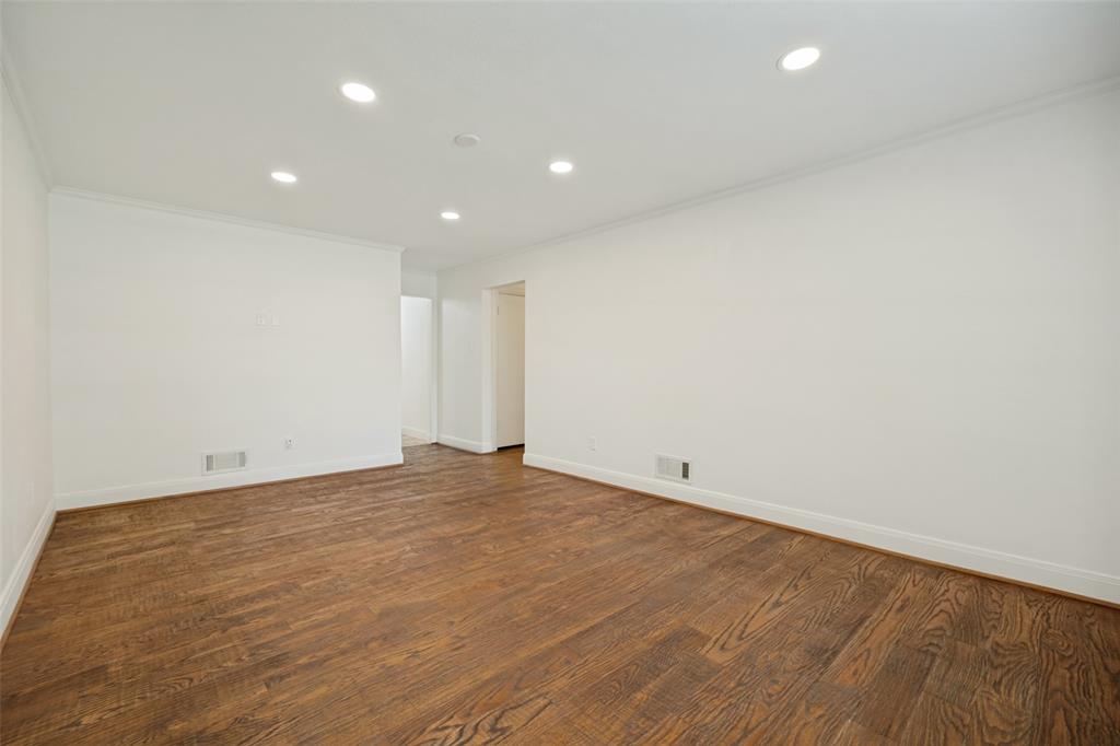 Recessed lighting, crown molding, wood-finish flooring, white walls, and white trim