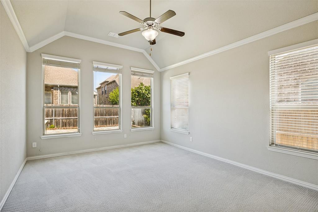 Vaulted ceilings with crown molding, ceiling fan, and multiple windows with blinds