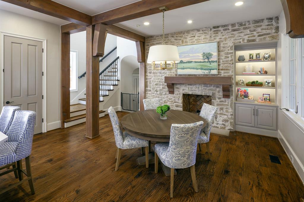 Breakfast room with gas fireplace, stone wall, and built-in shelving