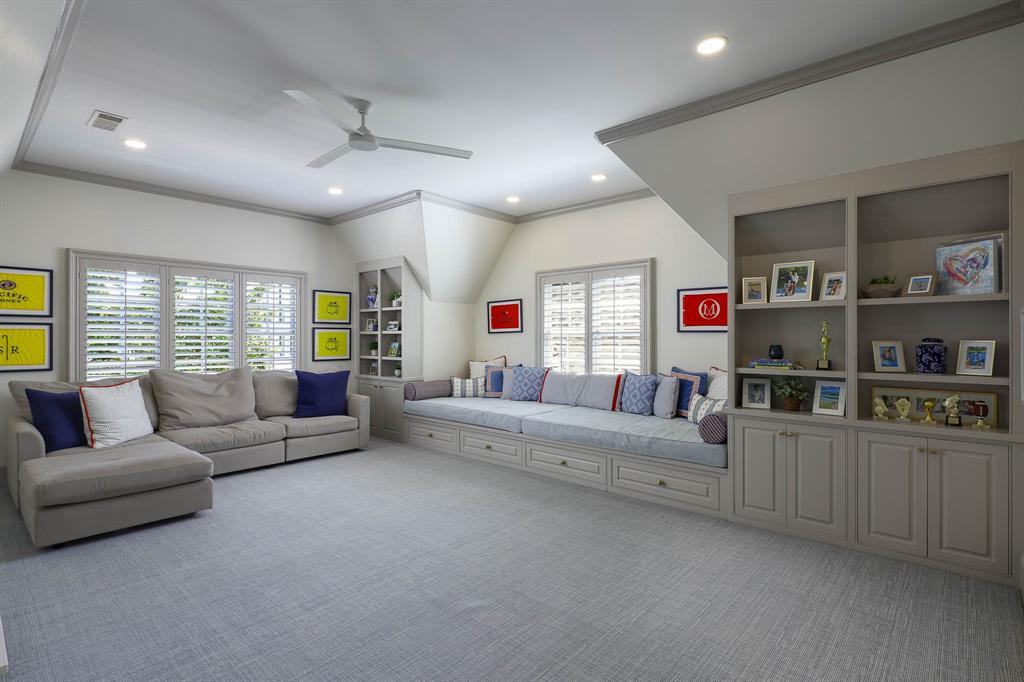 Playroom with oversized built-in window seat overlooking backyard and wet bar