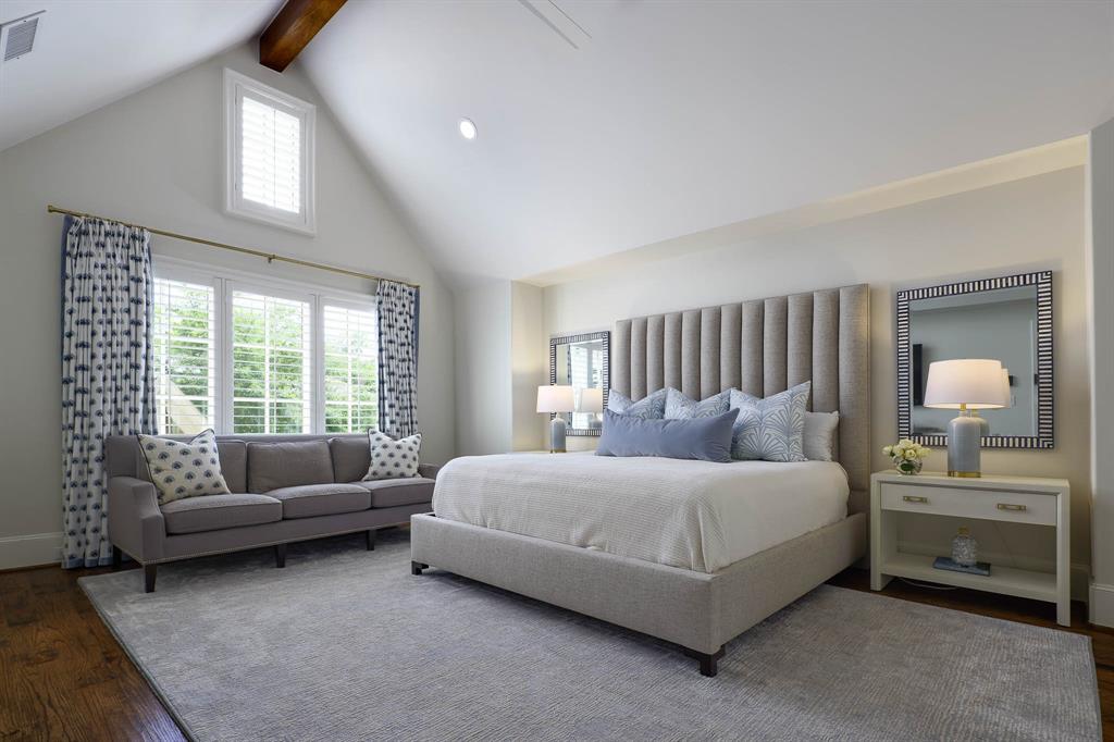 Primary suite with vaulted wood beamed ceiling and sitting area