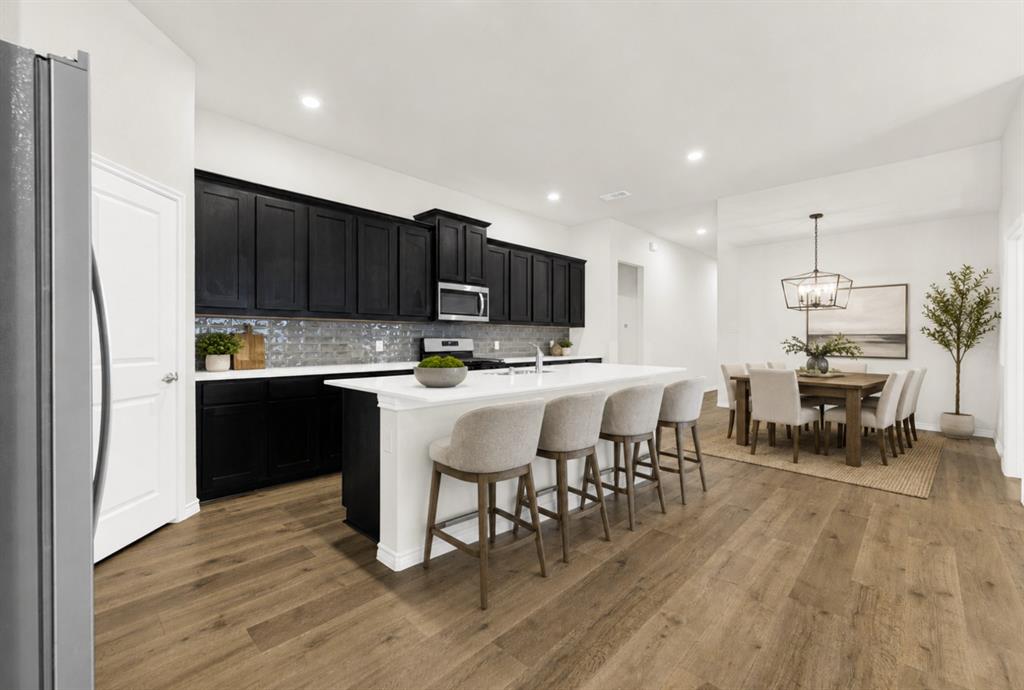 This unique view from the edge of the large refrigerator shows the seamless transition from the kitchen to the foyer. Getting groceries inside or unpacking supplies is a breeze when your kitchen is this central and accessible. *Virtually Staged* This unique view from the edge of the large refrigerator shows the seamless transition from the kitchen to the foyer. Getting groceries inside or unpacking supplies is a breeze when your kitchen is this central and accessible. *Virtually Staged*