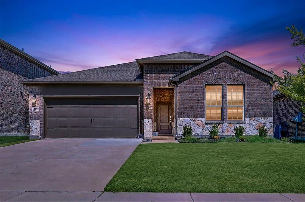 Welcome to 1932 Willie Ray in Anna. Set against a colorful evening sky, this virtual twilight angle showcases exterior sconce lighting and glowing front windows framing the stone facade. Imagine pulling into your driveway after a long day to be greeted by this warm, welcoming aesthetic. Welcome to 1932 Willie Ray in Anna. Set against a colorful evening sky, this virtual twilight angle showcases exterior sconce lighting and glowing front windows framing the stone facade. Imagine pulling into your driveway after a long day to be greeted by this warm, welcoming aesthetic.