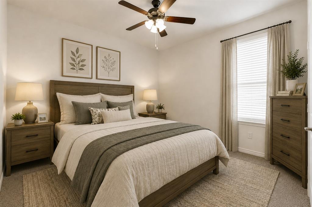 Soft neutral carpeting pairs with a sunlit window and ceiling fan to highlight this cozy secondary bedroom layout. Perfect for giving family or visiting guests a quiet, comfortable space of their own to relax. *Virtually Staged*