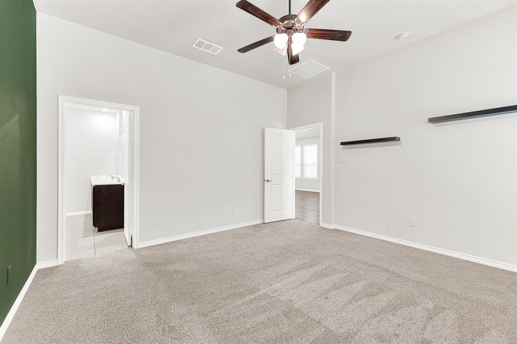 This viewpoint connects the peaceful bedroom area, including its wall shelves and ceiling fan, directly to the large window view and the entrance of the spa-inspired ensuite bathroom. Experience effortless luxury as you move freely between your private relaxation space and the well-appointed bathroom.