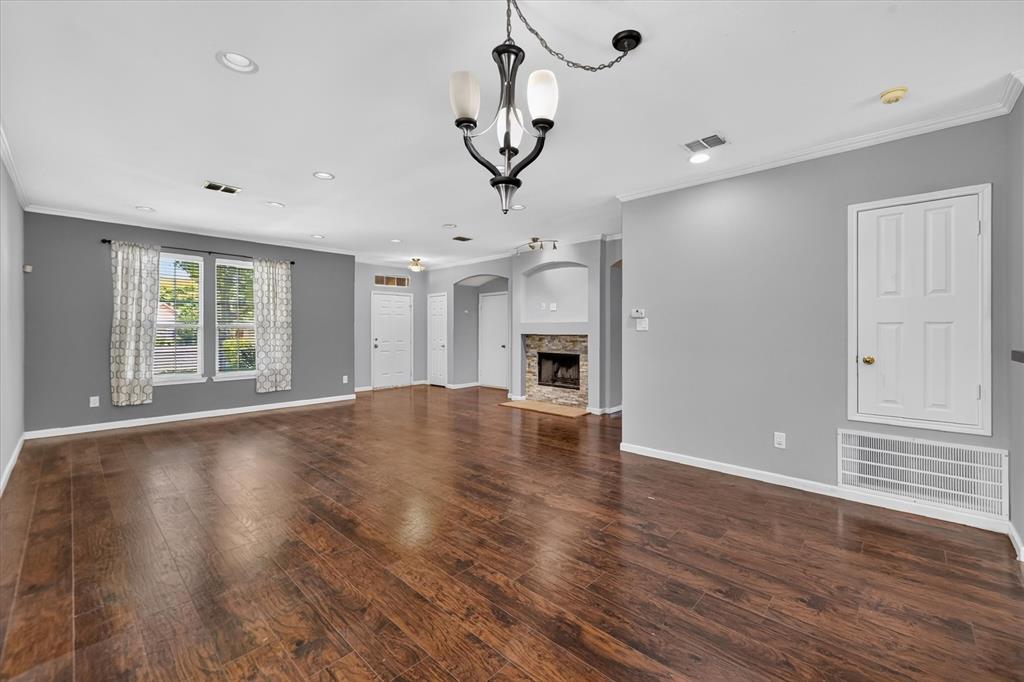 Wood-finish flooring throughout, recessed lighting, and a stone-faced fireplace