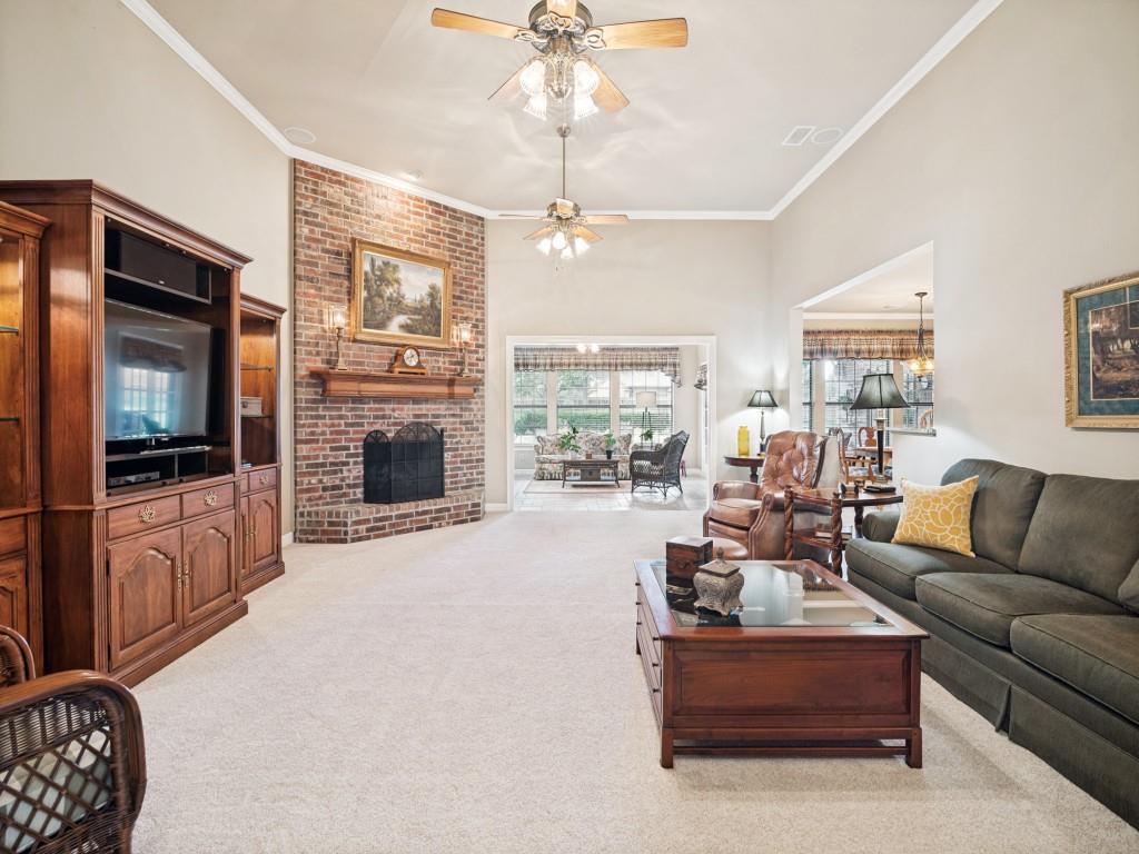 Oversized living room features a floor to ceiling fireplace with open views to the sunroom and kitchen. Oversized living room features a floor to ceiling fireplace with open views to the sunroom and kitchen.