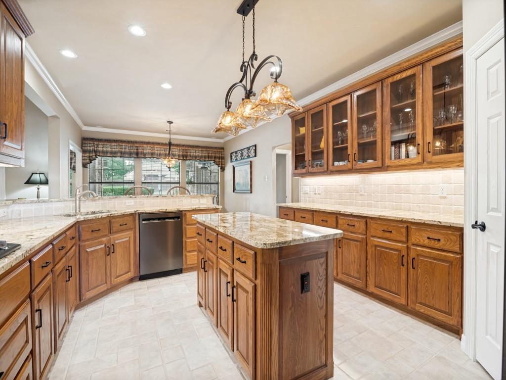 Spacious kitchen boasts granite countertops, decorator lighting and massive amounts of storage. Spacious kitchen boasts granite countertops, decorator lighting and massive amounts of storage.
