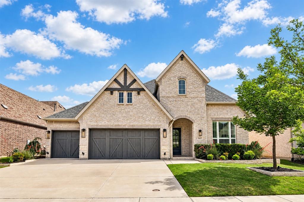 Light brick exterior with gabled roof lines and decorative wood accents Light brick exterior with gabled roof lines and decorative wood accents