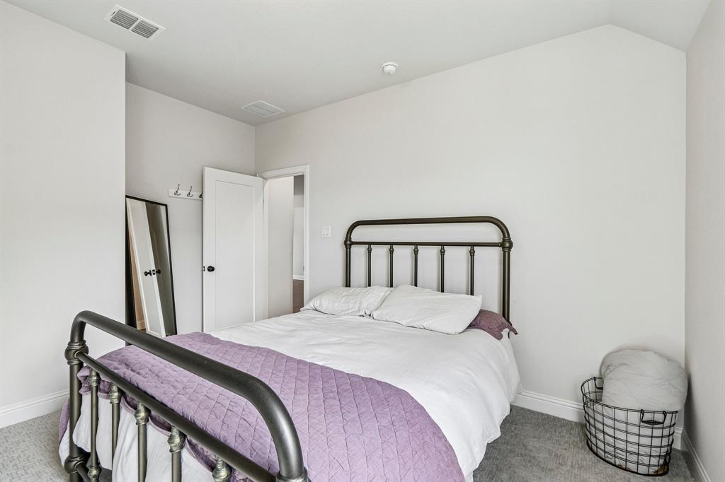 Carpeted room with bright white walls and a white paneled door
