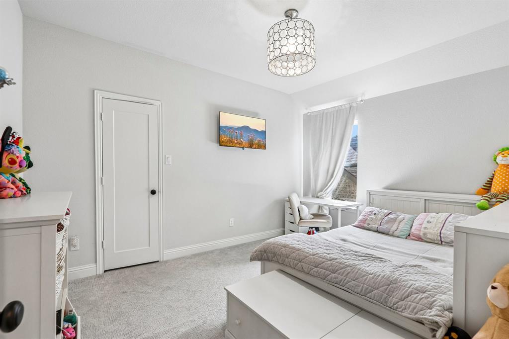 Wall-mounted television, recessed window with white drapery, and a contemporary ceiling light fixture