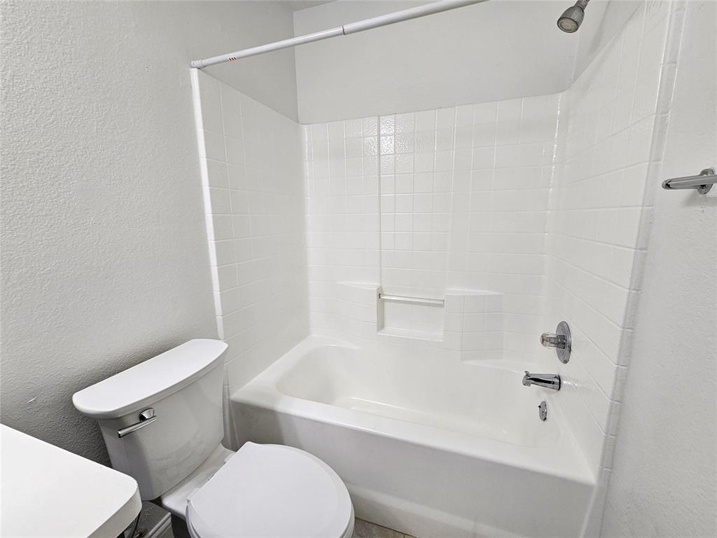 Tub/shower combination with white subway tile surround and chrome fixtures