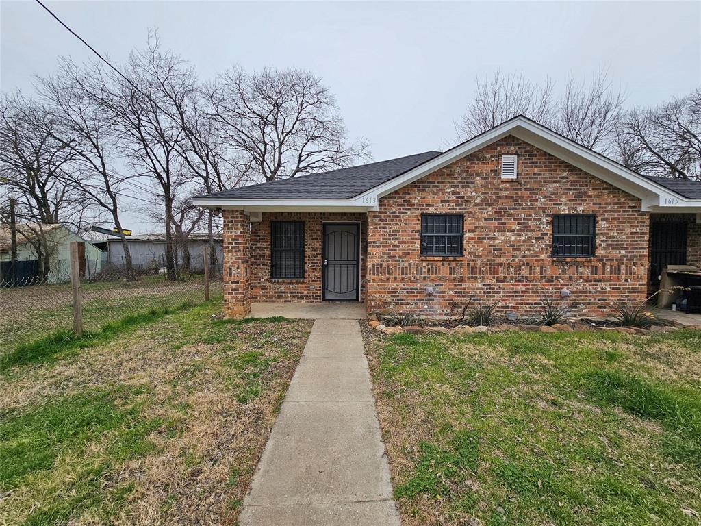 Brick exterior with a gabled roof and covered front porch