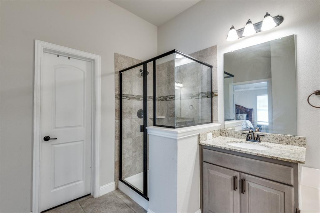 Walk-in shower with tiled surround and glass enclosure