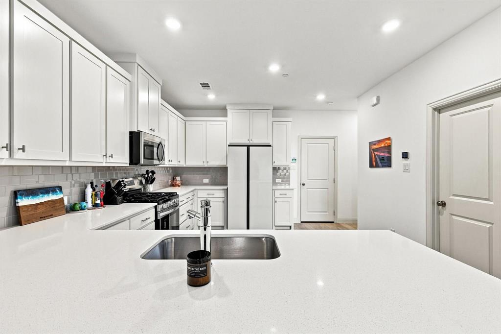 A kitchen that delivers on both style and function, with generous counter space, abundant cabinetry, stainless appliances, and an oversized island ready for entertaining.
