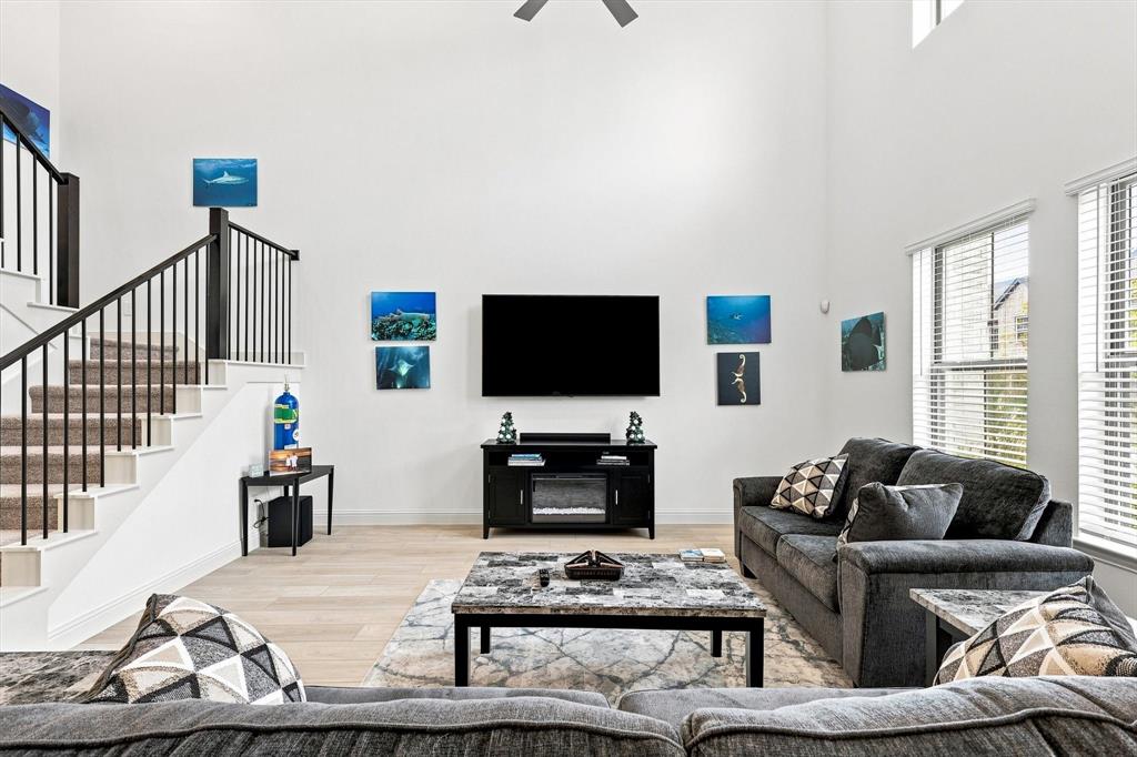Volume, light, and style come together in this spectacular living space, where towering ceilings create an undeniable sense of grandeur.