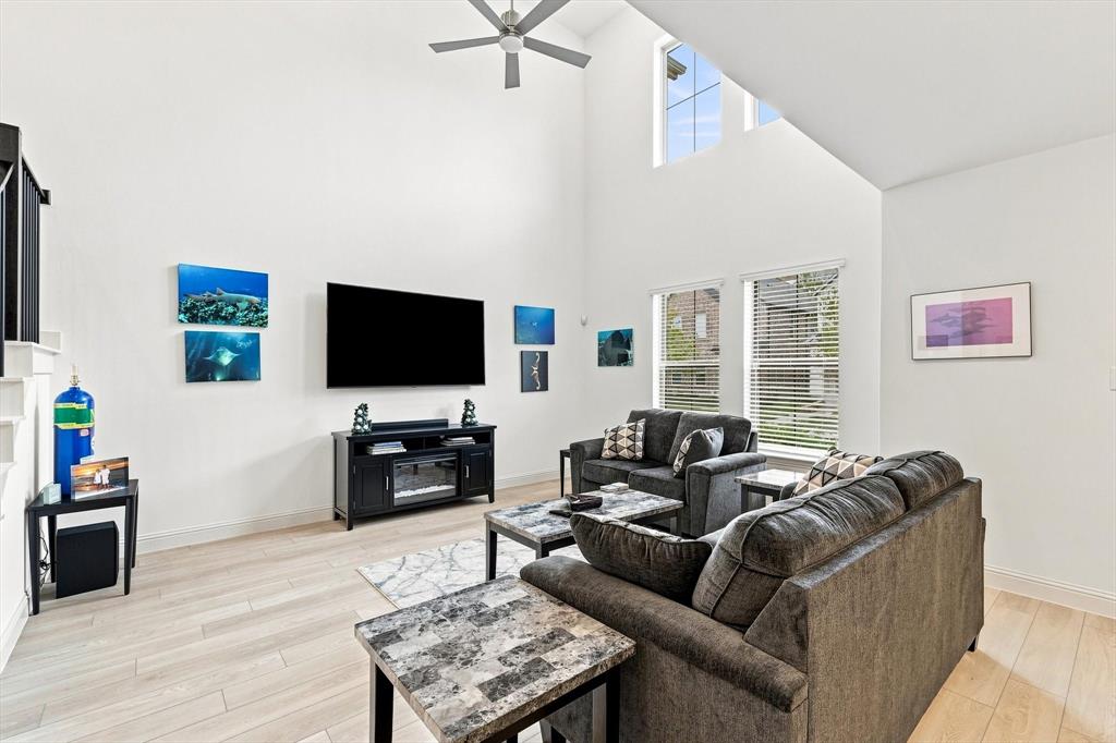 This is the wow moment. Soaring ceilings, incredible natural light, and an airy two-story design make this living room the showpiece of the home.