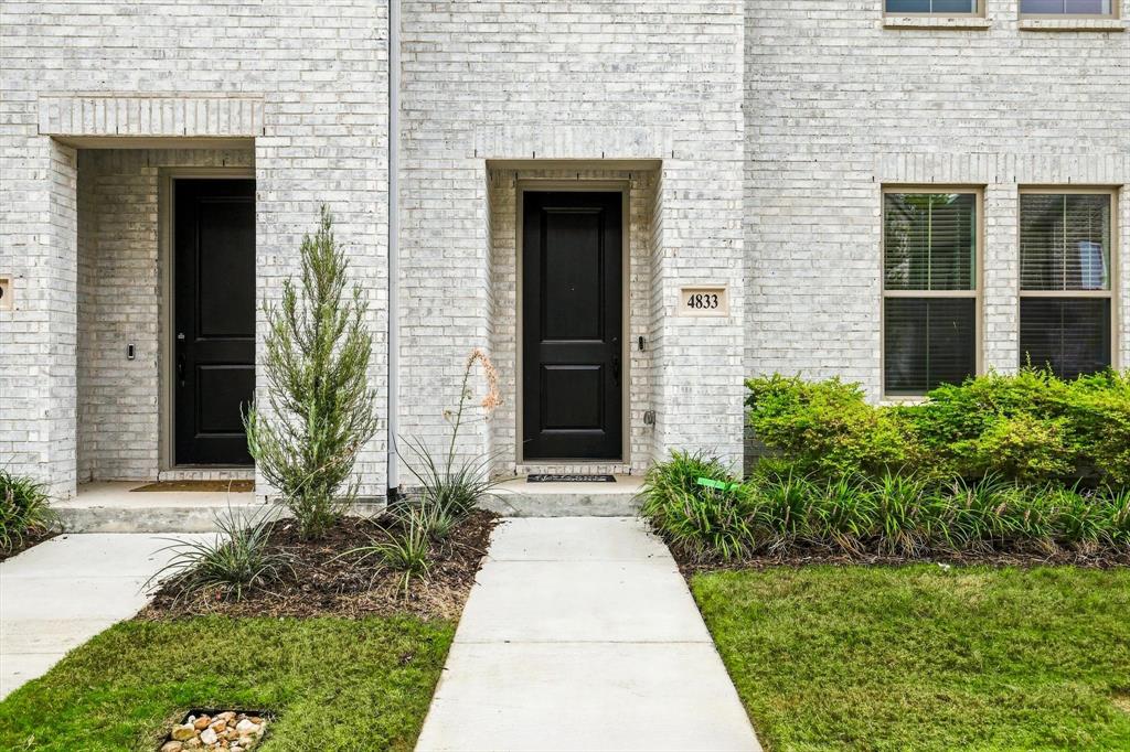 Welcome home. The bold black entry door against classic white brick creates a timeless, sophisticated entrance. Welcome home. The bold black entry door against classic white brick creates a timeless, sophisticated entrance.