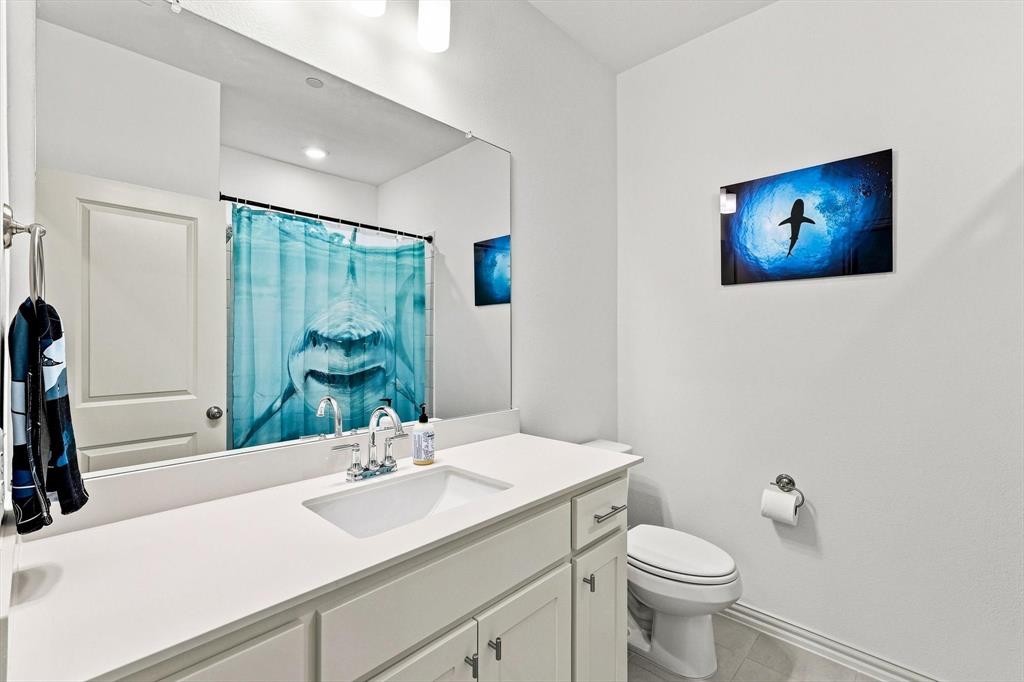 Fresh and functional, this full bath features a clean white vanity, generous counter space, and a bright, polished look.