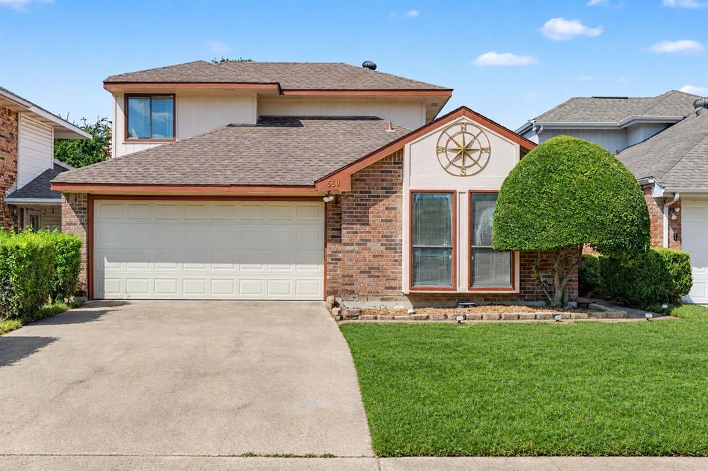 Brick and siding exterior featuring a two-car garage, concrete driveway, and a well-maintained lawn Brick and siding exterior featuring a two-car garage, concrete driveway, and a well-maintained lawn