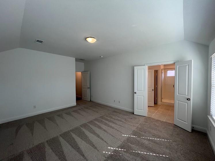 Vaulted ceiling, recessed lighting, double-door entry, tiled flooring, built-in shower