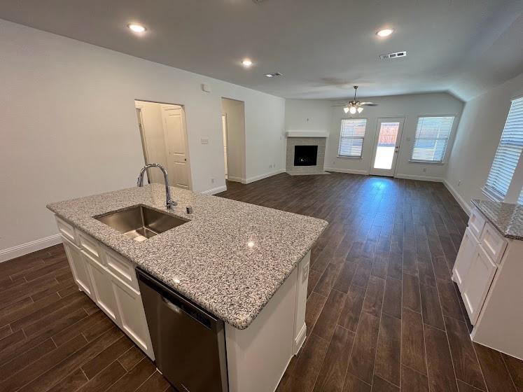 Kitchen island with a stainless steel sink, gooseneck faucet, and integrated dishwasher