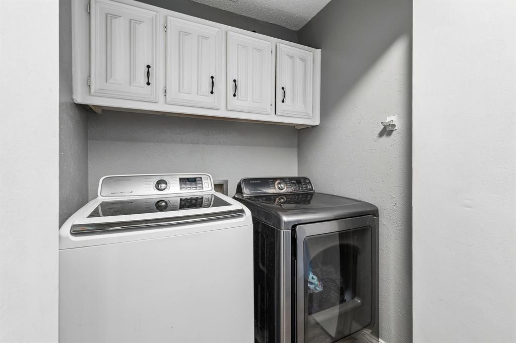 White upper cabinetry with black hardware