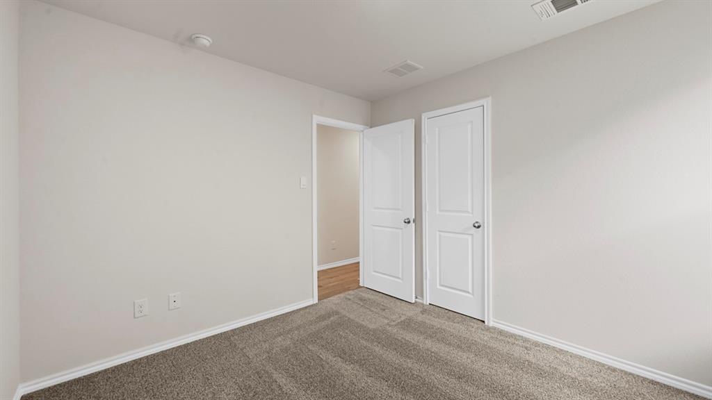 Neutral-toned walls complement the gray carpeting
