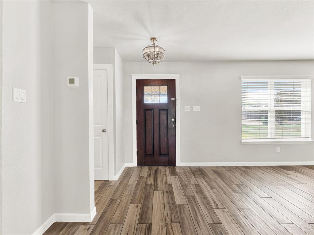 Welcome in! Durable, low maintenance, wood-look tile in the primary living spaces and fresh paint throughout Welcome in! Durable, low maintenance, wood-look tile in the primary living spaces and fresh paint throughout