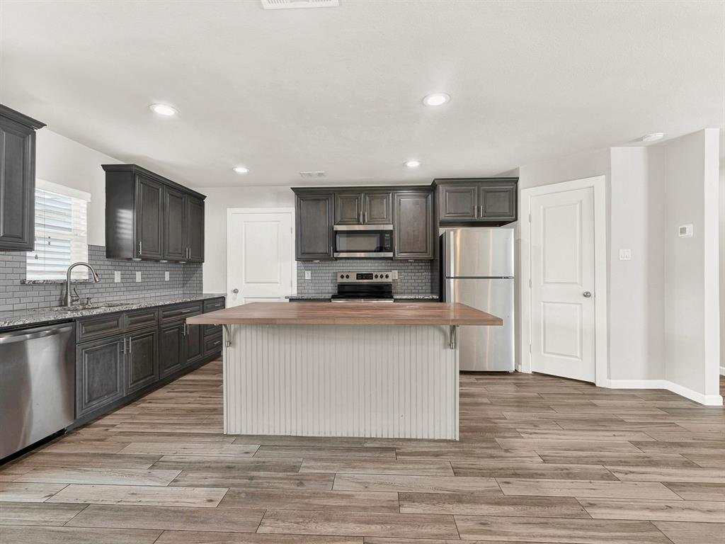 The kitchen has an oversized island with a breakfast bar and an extra large pantry The kitchen has an oversized island with a breakfast bar and an extra large pantry