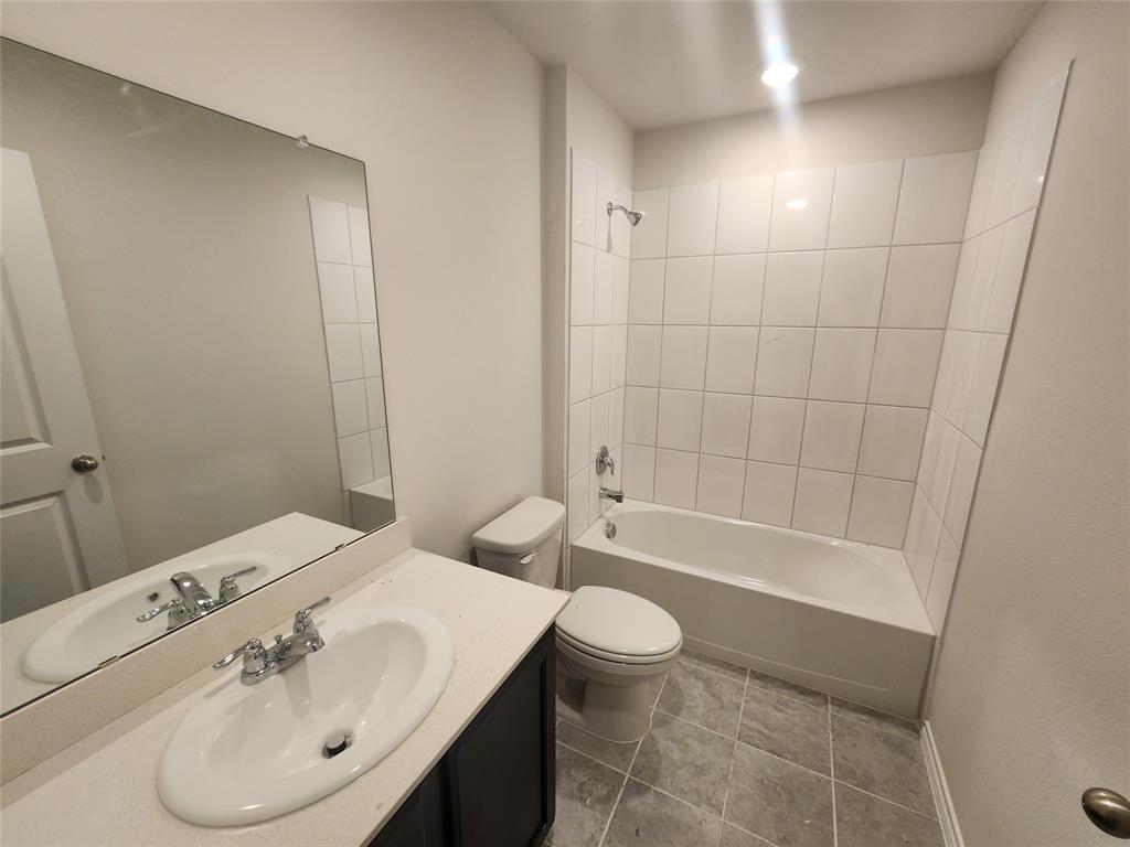 White vanity with an integrated sink, polished chrome faucet, and a large wall-mounted mirror