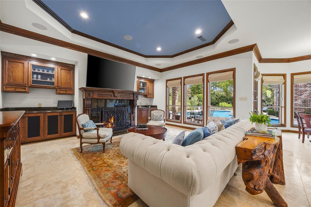 Inviting family room featuring a beautiful fireplace and custom built-ins.