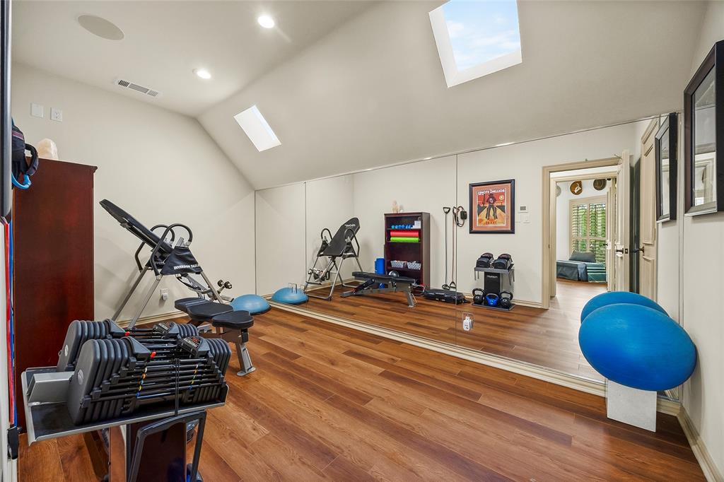 Dedicated exercise room with skylights and ample space for fitness equipment