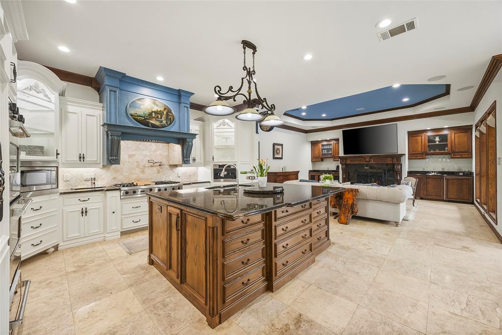 Gourmet kitchen featuring a large center island, premium appliances, and custom cabinetry.