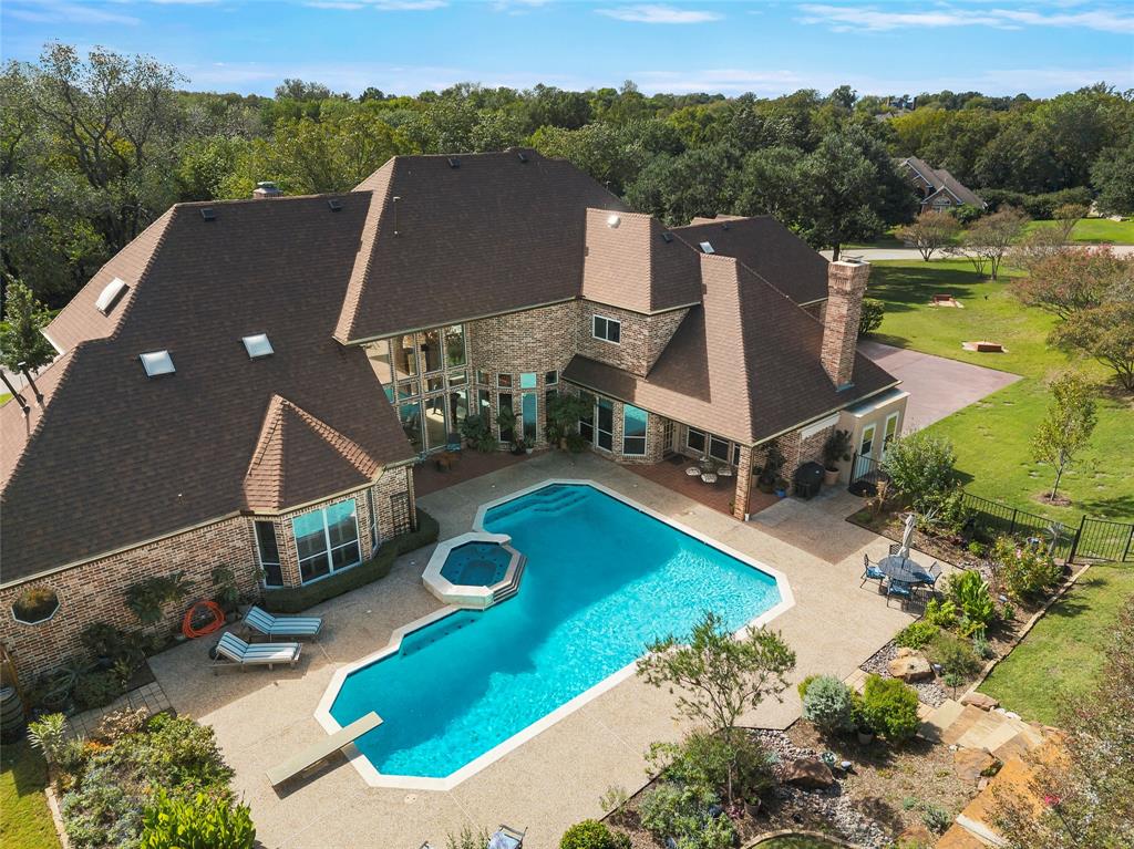 Resort-style backyard featuring a sparkling pool, spa, and outdoor entertaining areas.