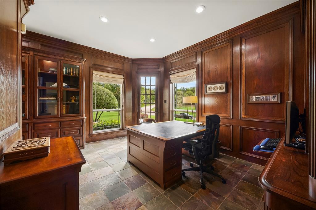 Distinguished wood-paneled study with custom built-ins and beautiful views.
