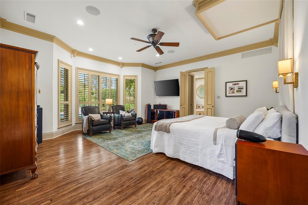Spacious bedroom featuring warm wood floors and beautiful natural light.