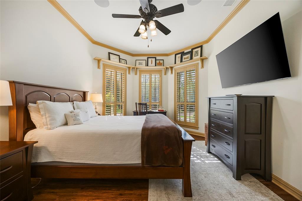 Spacious bedroom featuring architectural ceiling details and natural light.