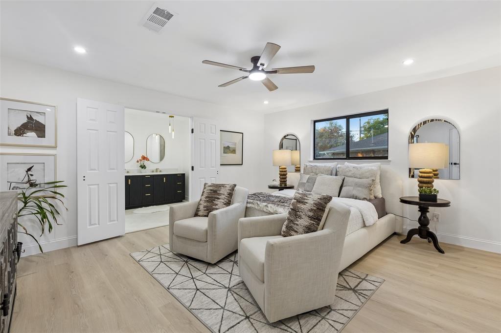 Spacious room featuring wood-finish flooring, recessed lighting, a ceiling fan, and a large window
