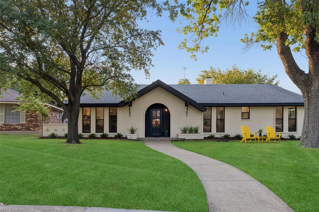 Single-story residence featuring a gray asphalt shingle roof and a light-colored brick exterior