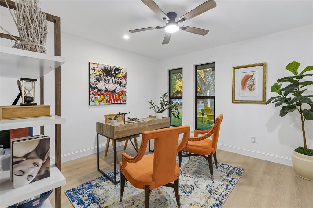 Light wood-finish flooring, built-in shelving, recessed lighting, and a ceiling fan with integrated light fixture