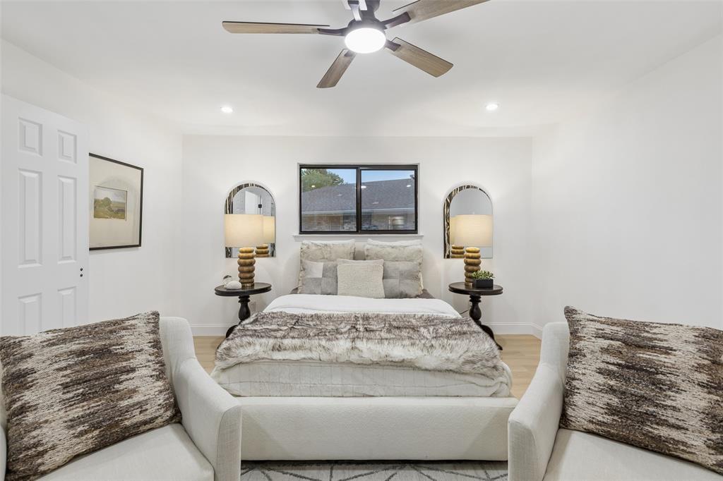 Recessed lighting, wood-finish flooring, ceiling fan, and a window with dark trim