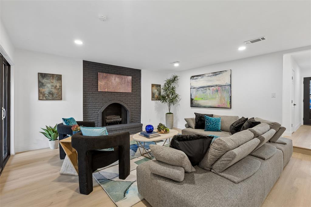 White walls, recessed lighting, and wood-finish flooring