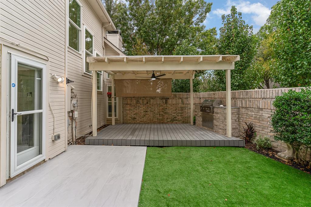 View of yard with ceiling fan and a wooden deck